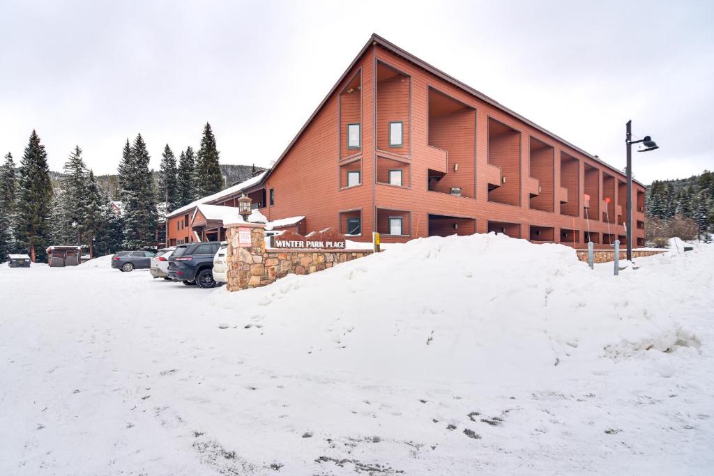 a pile of snow in front of a building at Walk to Winter Park Resort Condo with Hot Tub! in Winter Park