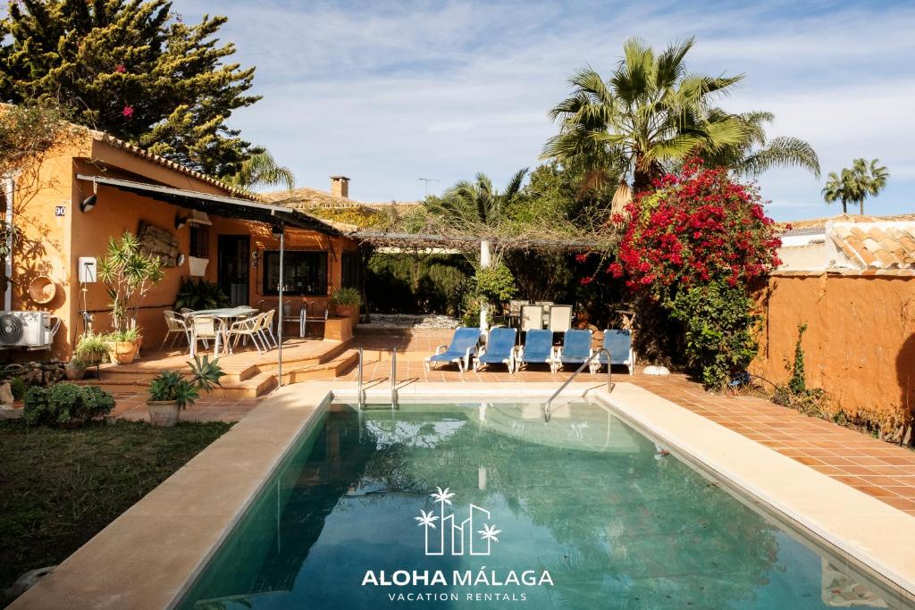 a swimming pool in the backyard of a house at LaCalma Village with private pool By AlohaMálaga in Málaga