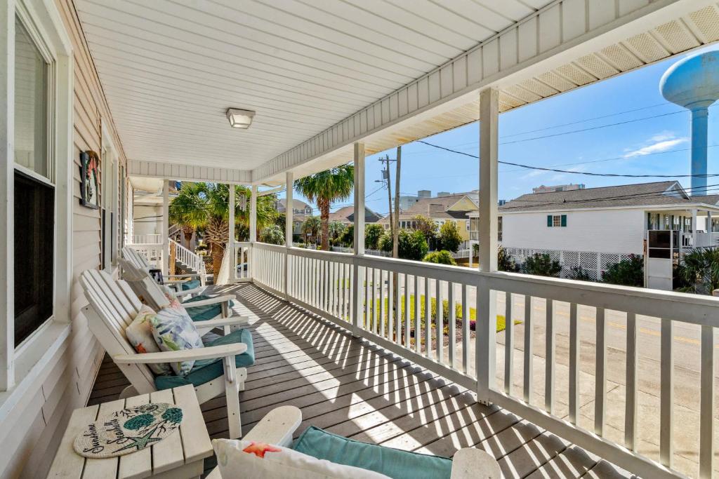 a porch with chairs and tables and a view of the beach at Sand Dollar- Approx 387 Feet to the Beach in Myrtle Beach