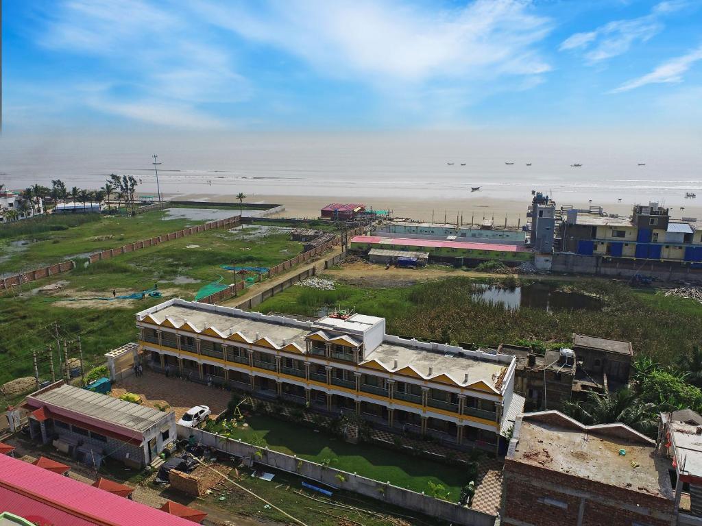 an aerial view of a building next to the beach at Sweet Dream Beach Resort !! 50 Meter From Beach !! in Mandarmoni