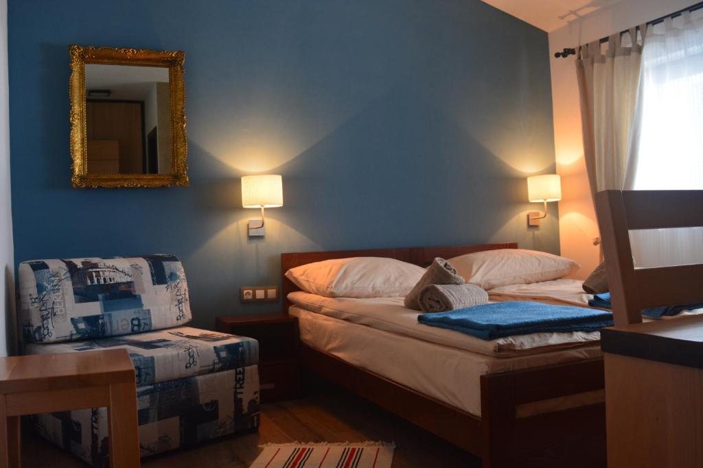 a bedroom with a bed and a mirror on the wall at Guest house Zavicaj Pale in Pale