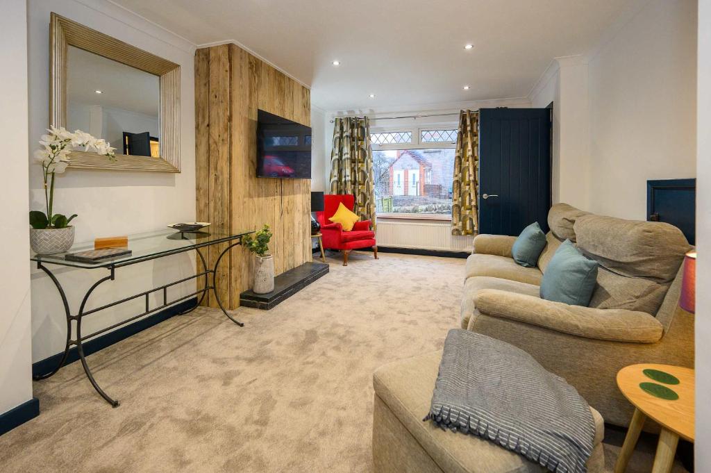 a living room with a couch and a table at LITTLE COTO Fully Equipped South West Home By STAE-Homes in Bristol