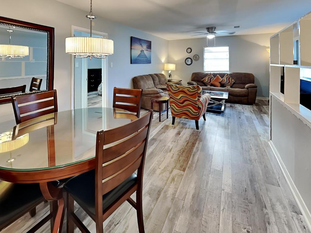 a dining room and living room with a table and chairs at Pleasure Pier Retreat #4 in Galveston
