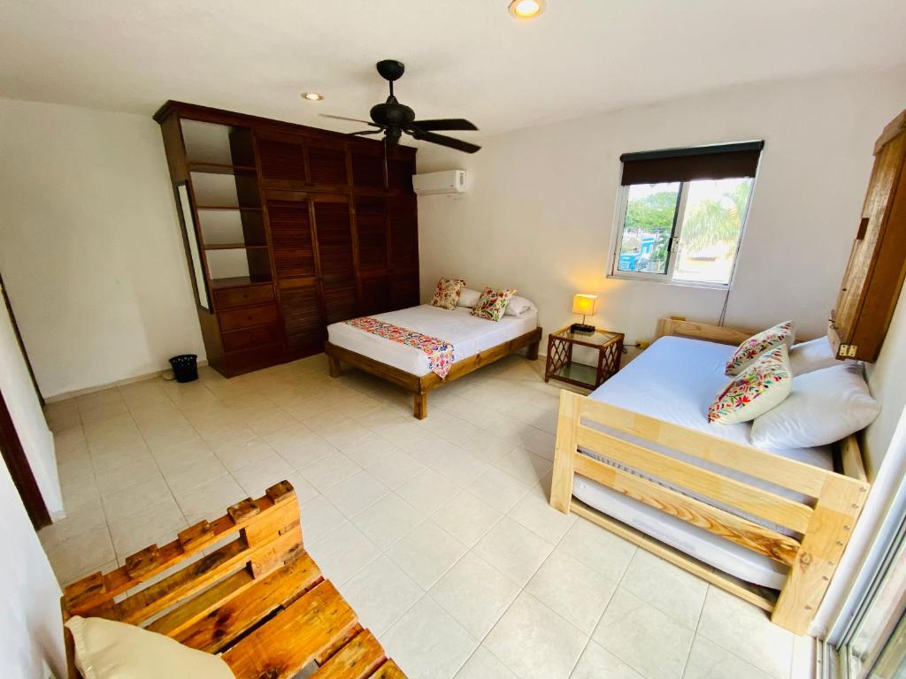 Postel nebo postele na pokoji v ubytování Aguacatl Cozumel