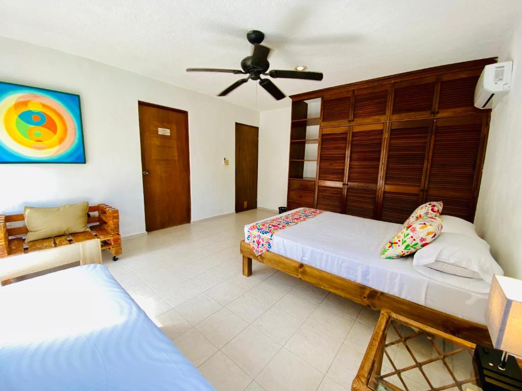 Postel nebo postele na pokoji v ubytování Aguacatl Cozumel