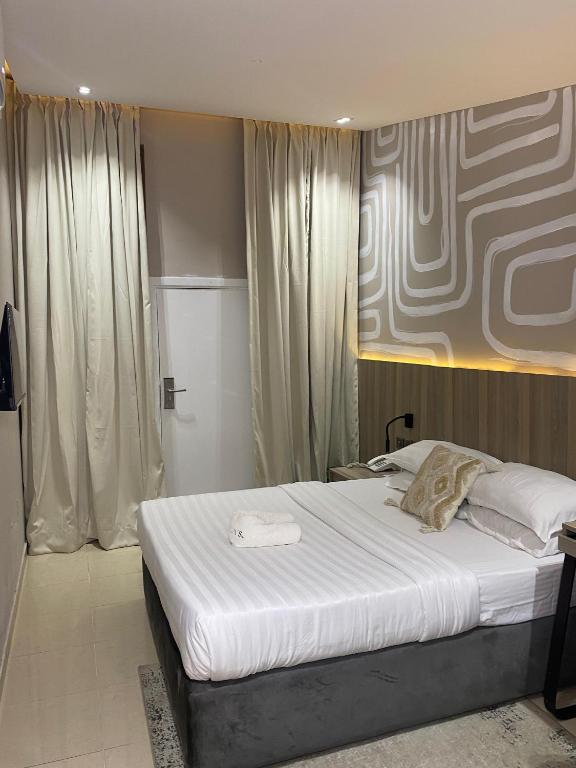 Postel nebo postele na pokoji v ubytování Lala's Boutique Hotel