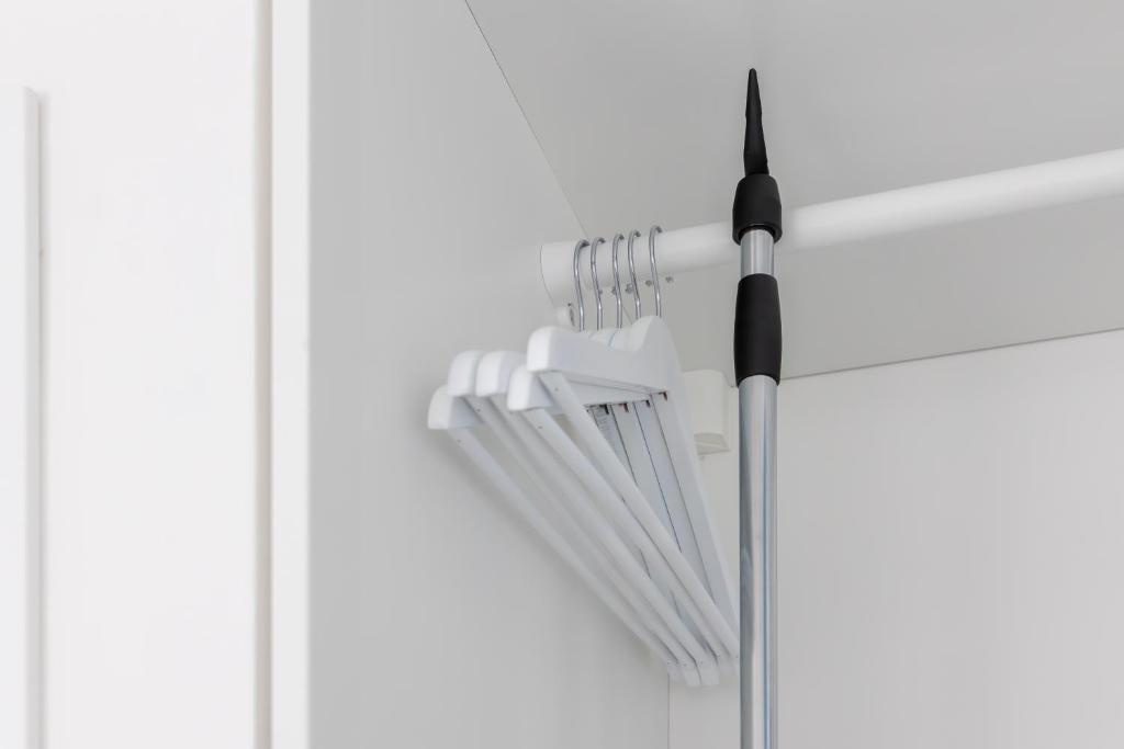a bunch of white forks hanging on a wall at Maddalena Rooms - Eja Sardinia in Cagliari
