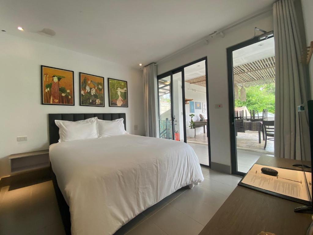 Postel nebo postele na pokoji v ubytování Coto Island Beach Village Homestay