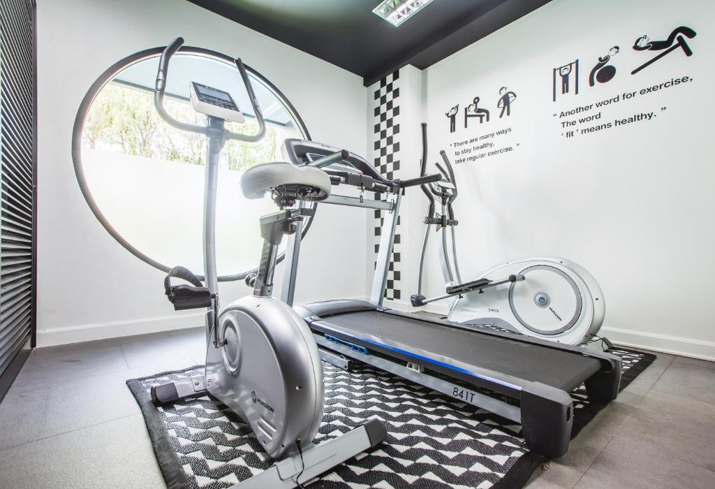 a gym with two ellipticals and a treadmill at Blu Monkey Hub and Hotel Phuket Town- Free All Day Coworking space in Phuket Town