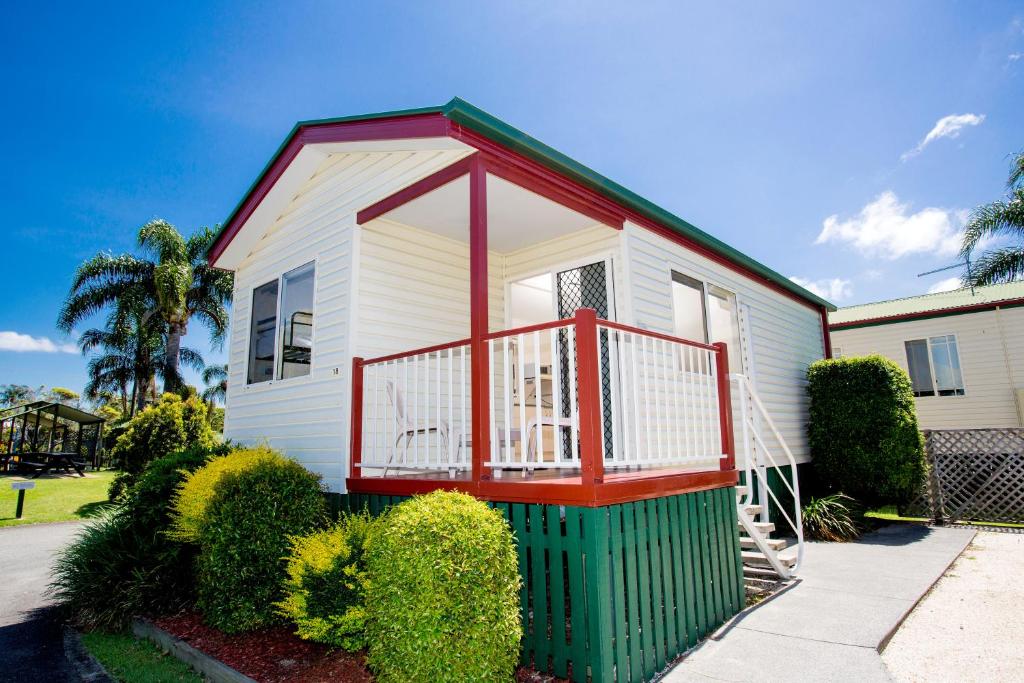 a small white house with a red balcony at Ingenia Holidays Kingscliff in Chinderah