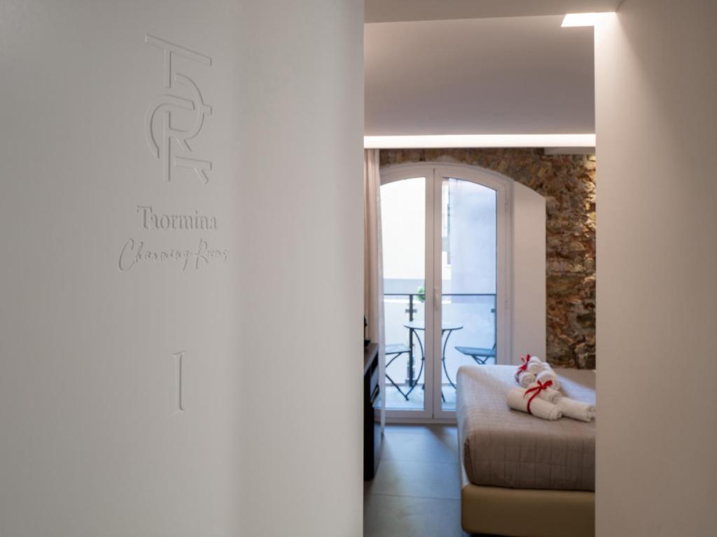 a living room with a couch and a table at Taormina charming rooms in Taormina