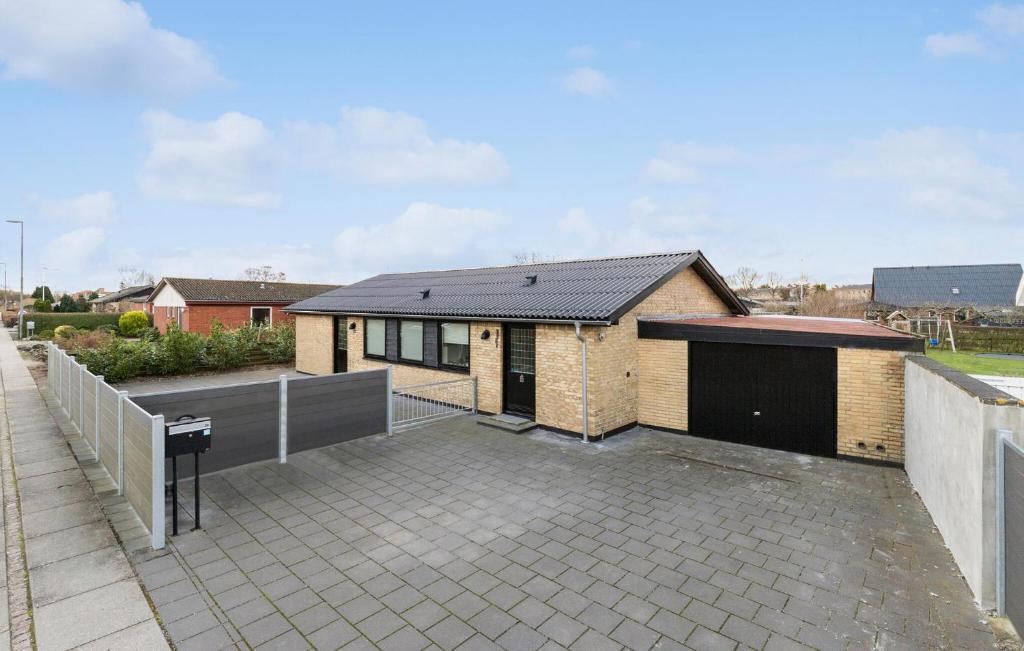 a house with a large patio in front of it at 2 Bedroom Stunning Home In Grenaa in Grenå