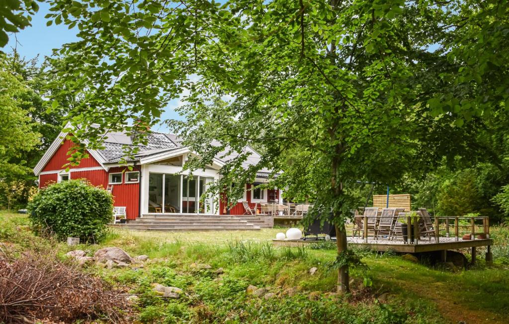 a red house with a porch and a deck at 3 Bedroom Amazing Home In Ronneby in Ronneby