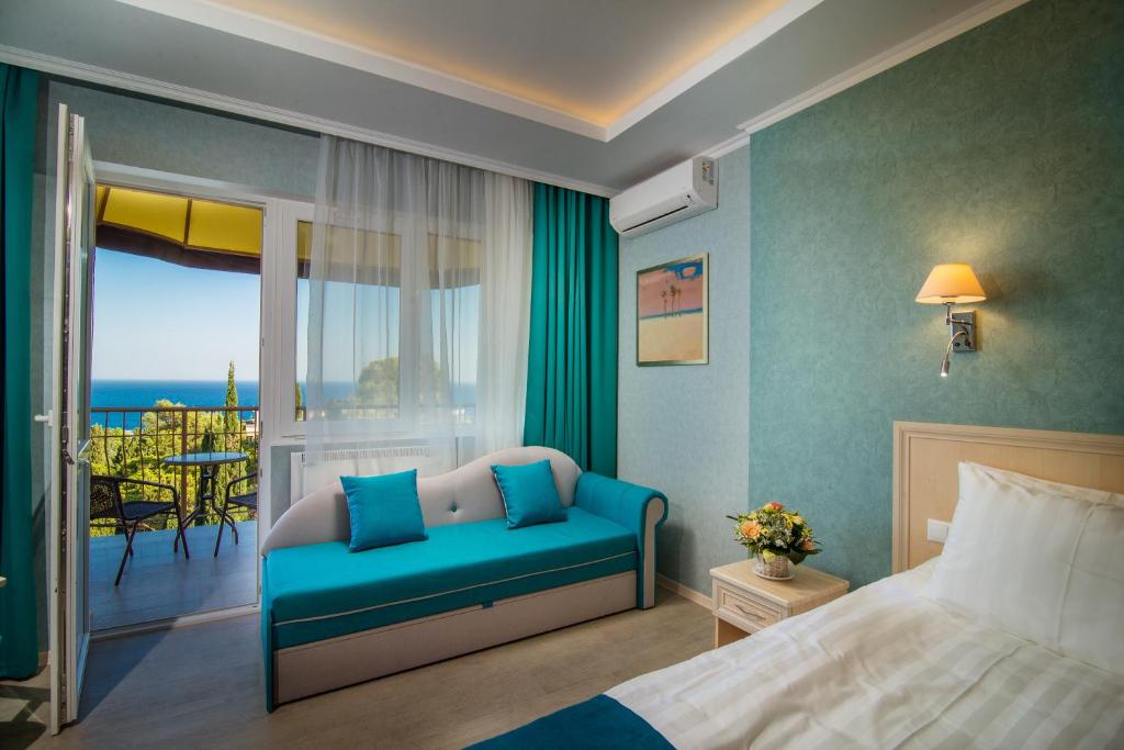 a bedroom with a bed and a view of the ocean at Aquapark-Hotel Atlantida in Yalta