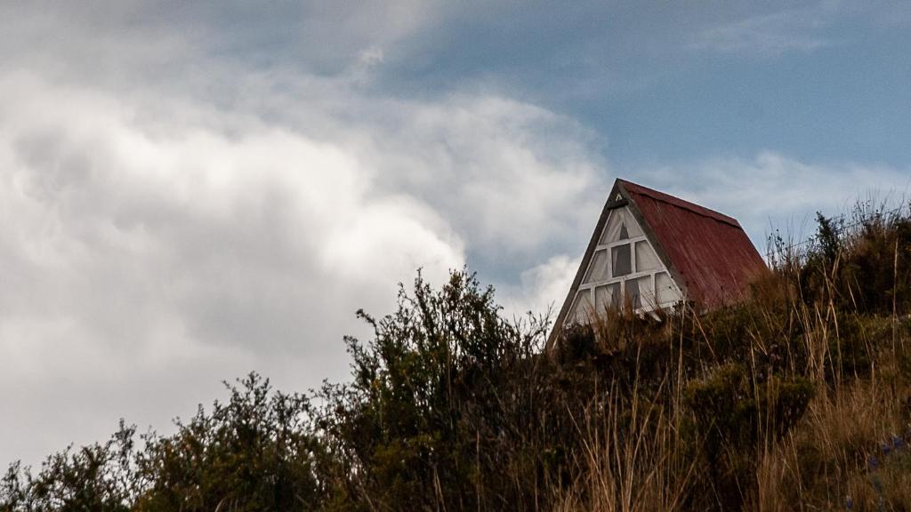 a barn sitting on top of a hill at Illamama in La Paz