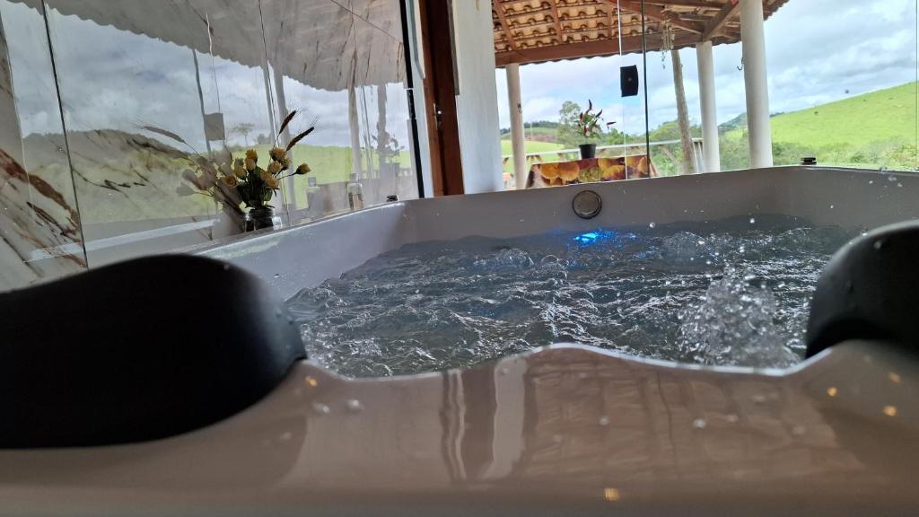 a jacuzzi tub with water in it at Sítio Ramos casa azul in Cunha