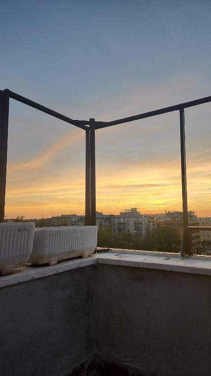 a view of the sunset from the roof of a building at Attico Panoramico Gardenie in Rome