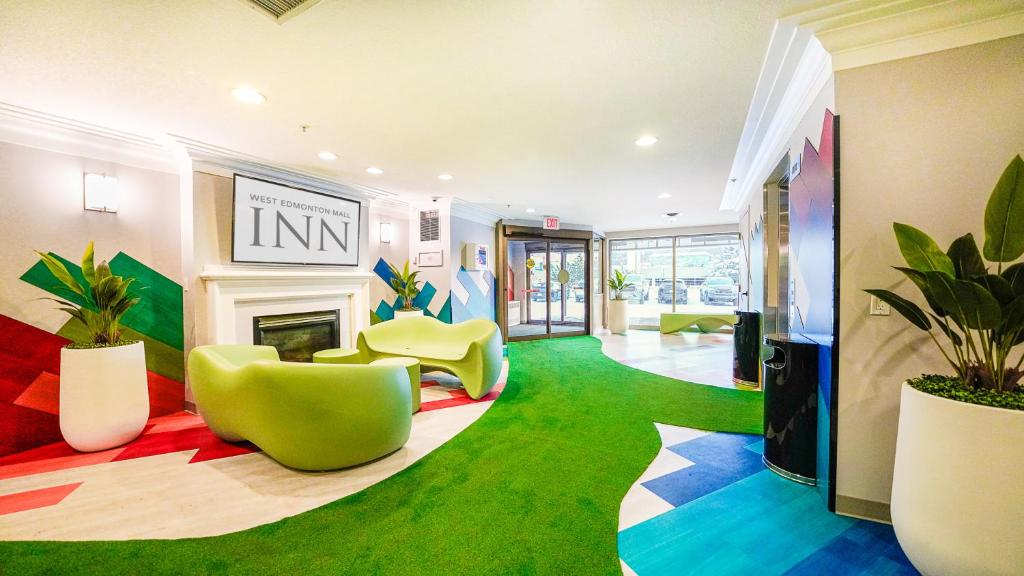 a lobby with colorful floors and chairs and a fireplace at West Edmonton Mall Inn in Edmonton