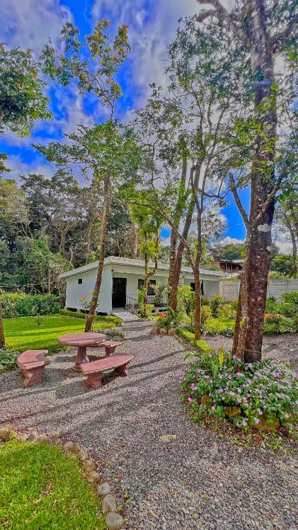 a park with picnic tables and trees and a building at Monteverde Magic Mountain in Monteverde Costa Rica