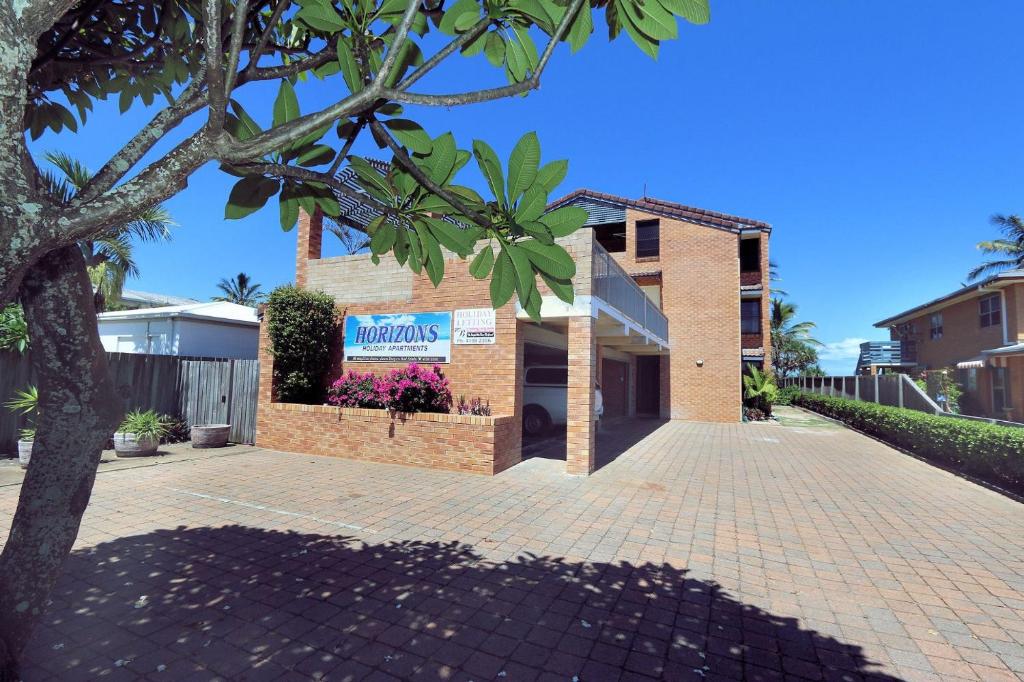 a brick building with a sign on it at Horizons 3 in Bargara