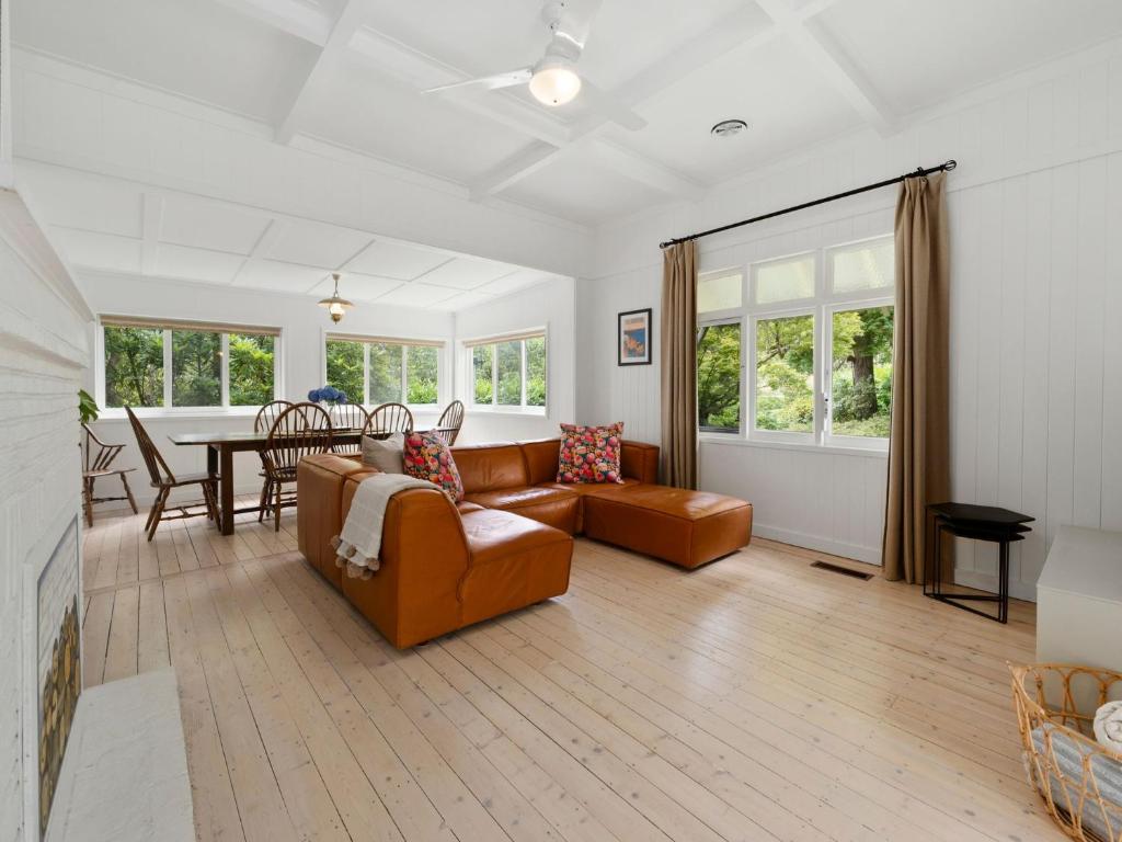 a living room with a couch and a table at Westlee Cottage in Wentworth Falls