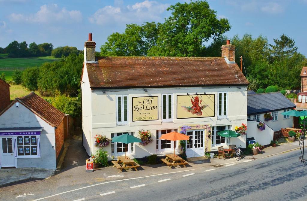 a toy building with tables and umbrellas on a street at The Old Red Lion in Thame