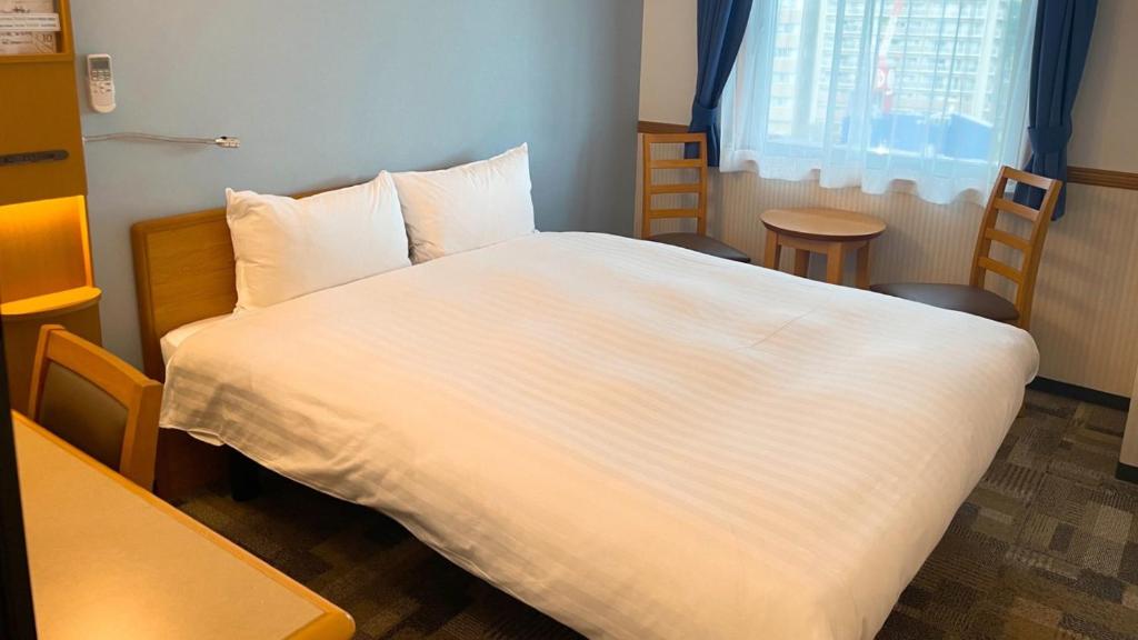 Postel nebo postele na pokoji v ubytování Toyoko Inn Mito-eki Minami-guchi