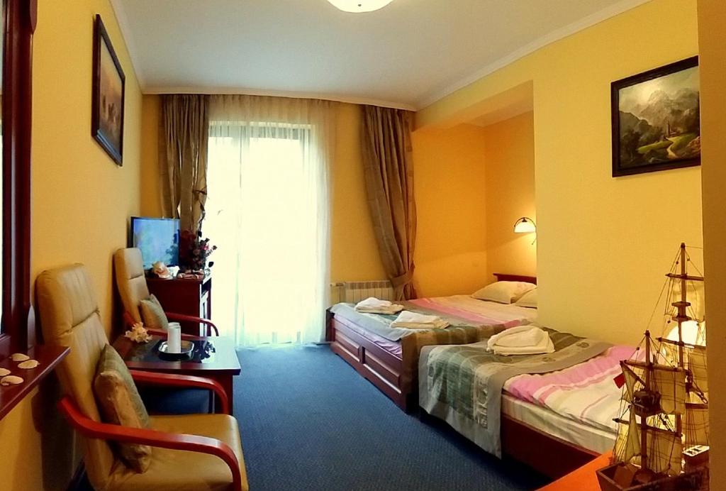 Postel nebo postele na pokoji v ubytování Hotel Spinaker