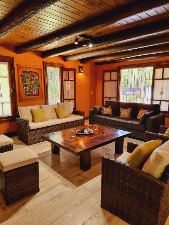 a living room with couches and a coffee table at El Charanguito Casa Quinta in Capilla del Señor