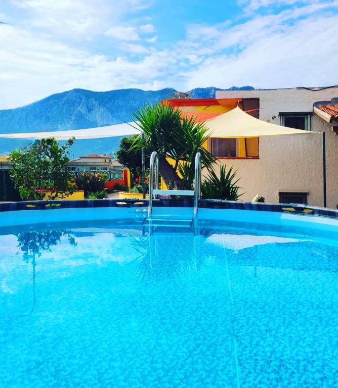 a large swimming pool in front of a building at Casa del Sole Irgoli - BIKERS HOME in Irgoli