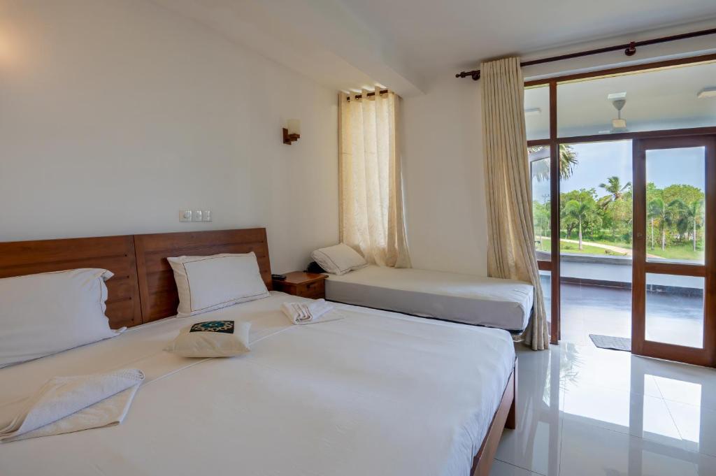 Postel nebo postele na pokoji v ubytování Abhayawewa Resort