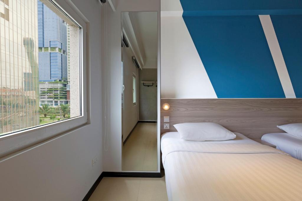 Postel nebo postele na pokoji v ubytování ibis budget Phnom Penh Riverside