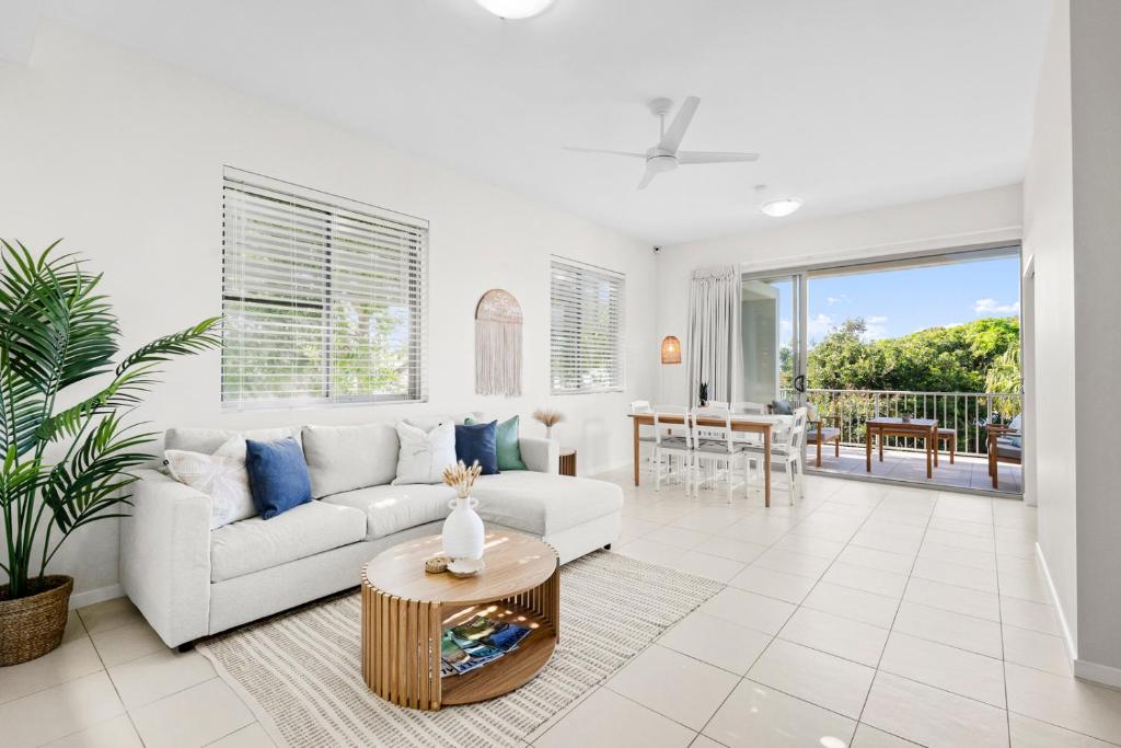 a living room with a couch and a table at Drift Apartments - Tweed Coast Holidays ® in Kingscliff