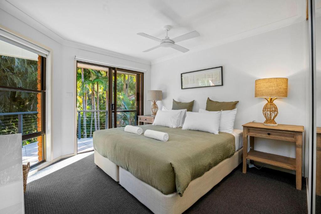 a bedroom with a large bed and a window at Calinda Sol 11 in Byron Bay