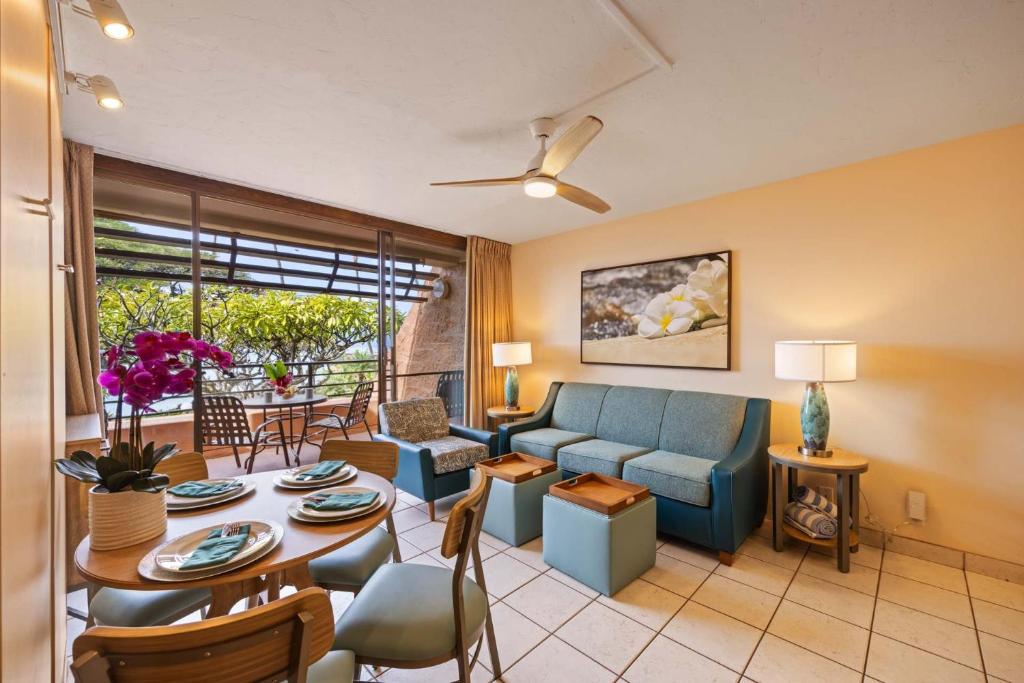 a living room with a couch and a table at Kuleana Club #510 - Ocean View -1 bedroom & 1 bathroom - 2nd Floor in Kahana