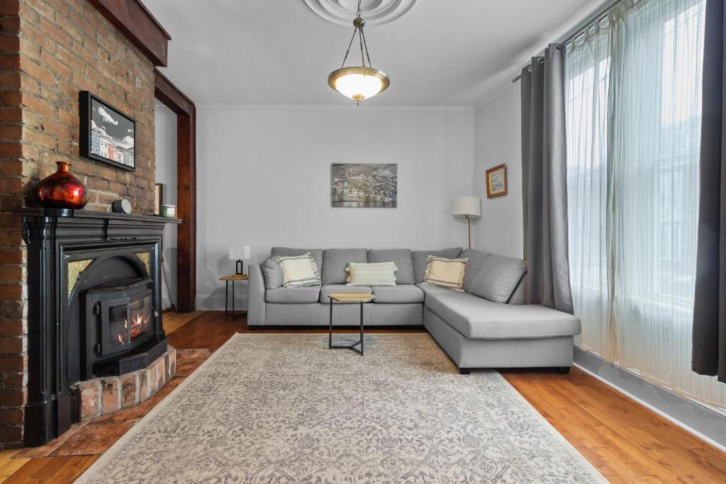 a living room with a couch and a fireplace at Victoria Family Home King Patio 2 Ba Bbq in St. John's