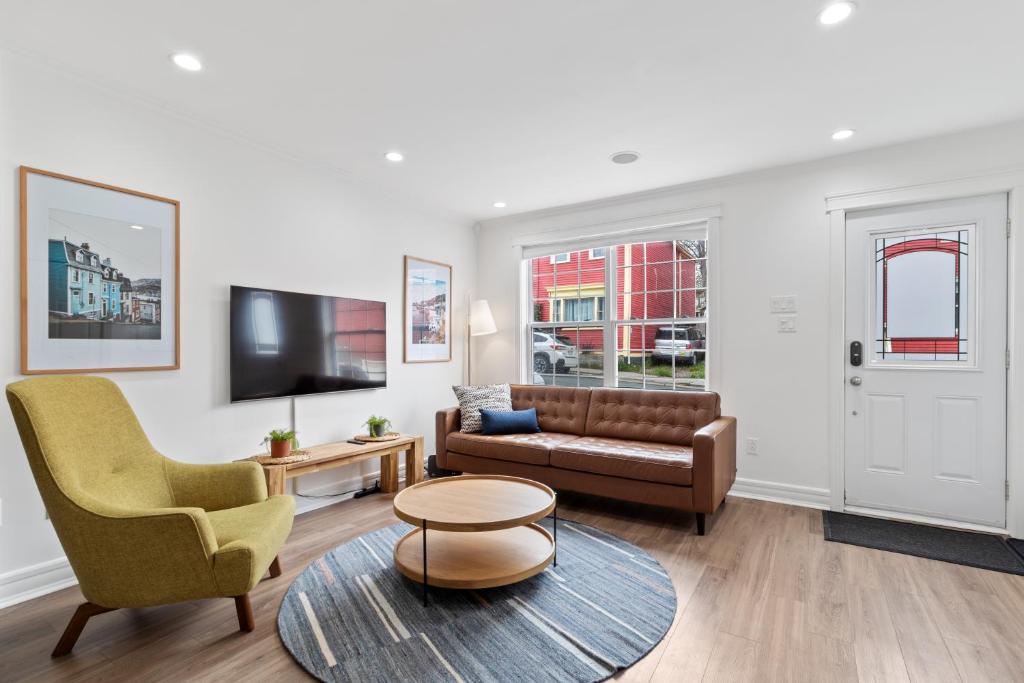 a living room with a couch and a chair at Wood House King Bd 2 Queens Fire Pit in St. John's