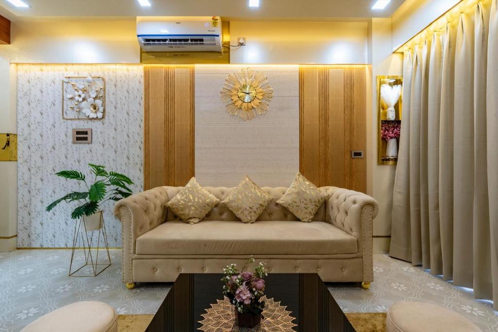 a living room with a couch and a table at Goa Riviera in Goa