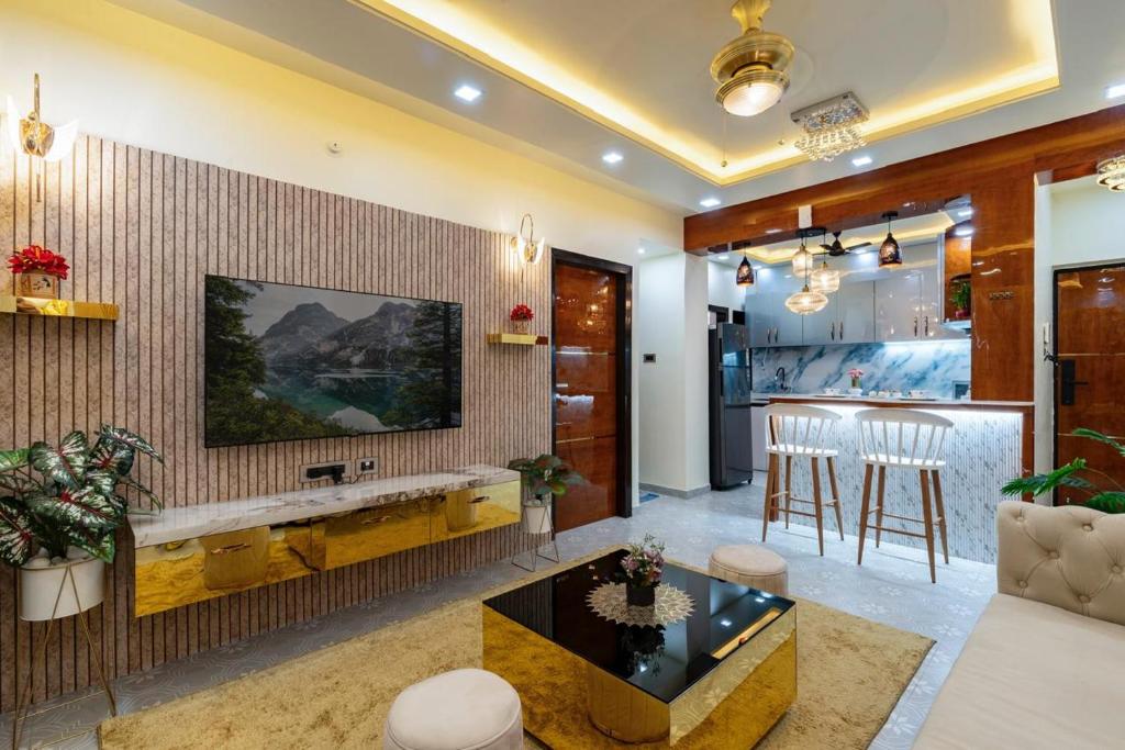 a living room with a large television and a table at Goa Riviera in Goa