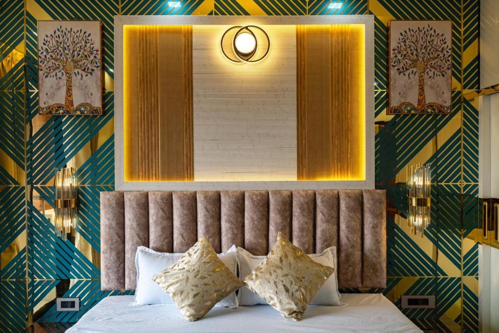 a bedroom with a bed with a mirror and a window at Goa Riviera in Goa