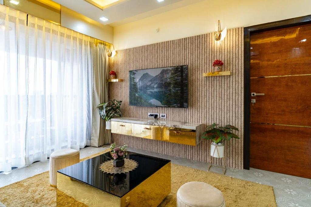 a living room with a sink and a table at Goa Riviera in Goa