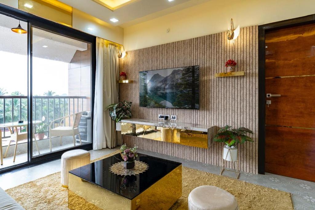 a living room with a sink and a table at Goa Riviera in Goa
