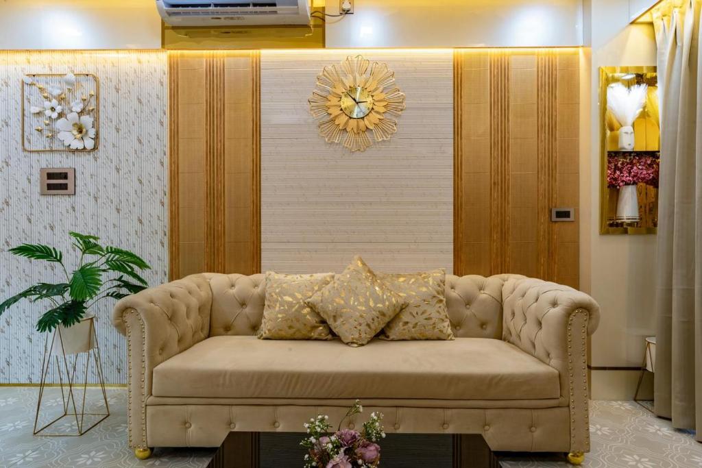 a living room with a couch in front of a wall at Goa Riviera in Goa