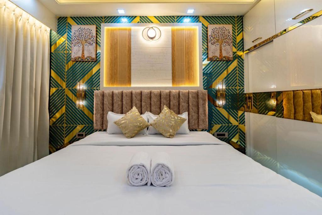 a bedroom with a bed with two pillows on it at Goa Riviera in Goa