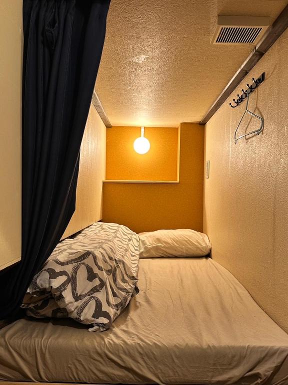 Postel nebo postele na pokoji v ubytování Hostel Furoya