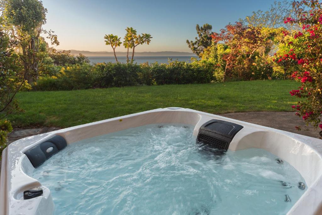 a bath tub with water in it in a yard at Tranquil Tides - You'll love it! in Nelson