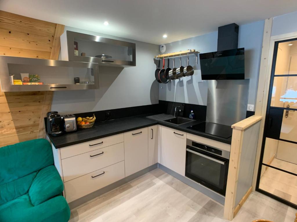 a small kitchen with a sink and a stove at Le studio de mimi in Le Grand-Bornand