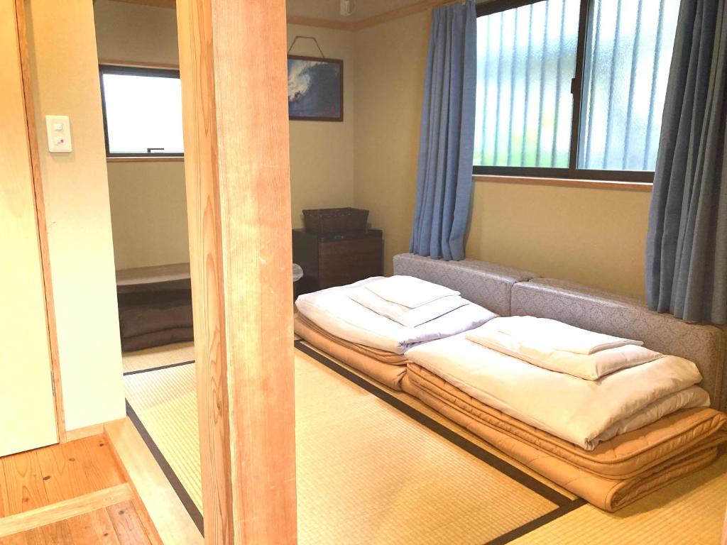 Postel nebo postele na pokoji v ubytování Guest House Kamakura Zen-ji