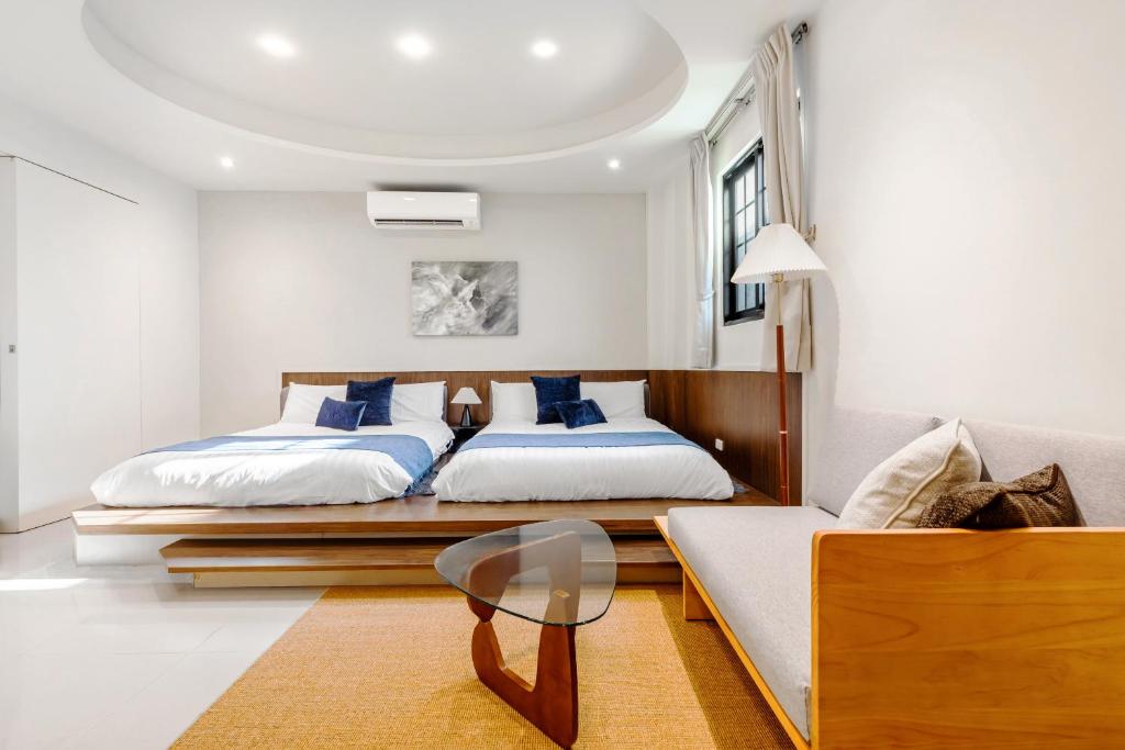 Postel nebo postele na pokoji v ubytování Jiufen Harmony Inn
