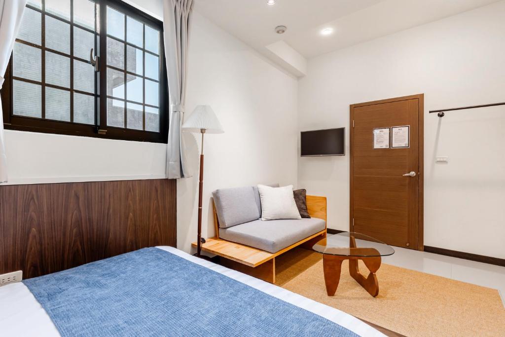 Postel nebo postele na pokoji v ubytování Jiufen Harmony Inn